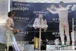 Lewis Hamilton (GBR) Mercedes AMG F1 and race winner Nico Rosberg (GER) Mercedes AMG F1 celebrate on the podium. 29.11.2015. Formula 1 World Championship, Rd 19, Abu Dhabi Grand Prix, Yas Marina Circuit, Abu Dhabi, Race Day.