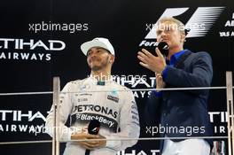 (L to R): Lewis Hamilton (GBR) Mercedes AMG F1 on the podium with David Coulthard (GBR) Red Bull Racing and Scuderia Toro Advisor / BBC Television Commentator. 29.11.2015. Formula 1 World Championship, Rd 19, Abu Dhabi Grand Prix, Yas Marina Circuit, Abu Dhabi, Race Day.