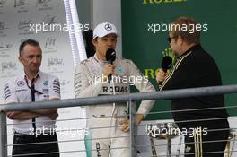 The podium (L to R): Paddy Lowe (GBR) Mercedes AMG F1 Executive Director (Technical) with Nico Rosberg (GER) Mercedes AMG F1 and Sir Elton John (GBR). 25.10.2015. Formula 1 World Championship, Rd 16, United States Grand Prix, Austin, Texas, USA, Race Day.