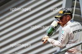 Lewis Hamilton (GBR) Mercedes AMG F1 celebrates his third position with the champagne on the podium. 28.08.2016. Formula 1 World Championship, Rd 13, Belgian Grand Prix, Spa Francorchamps, Belgium, Race Day.