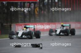 Lewis Hamilton (GBR) Mercedes AMG F1 W07 Hybrid and team mate Nico Rosberg (GER) Mercedes AMG F1 W07 Hybrid pass debris from the Sauber C35 of Marcus Ericsson (SWE) Sauber F1 Team. 13.11.2016. Formula 1 World Championship, Rd 20, Brazilian Grand Prix, Sao Paulo, Brazil, Race Day.
