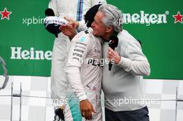 (L to R): race winner Lewis Hamilton (GBR) Mercedes AMG F1 with Michael Douglas (USA) Actor on the podium. 12.06.2016. Formula 1 World Championship, Rd 7, Canadian Grand Prix, Montreal, Canada, Race Day.