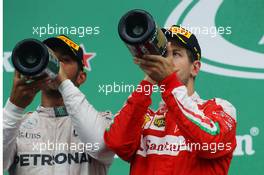 (L to R): Race winner Lewis Hamilton (GBR) Mercedes AMG F1 and race winner Sebastian Vettel (GER) Ferrari celebrate on the podium. 12.06.2016. Formula 1 World Championship, Rd 7, Canadian Grand Prix, Montreal, Canada, Race Day.
