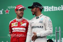 (L to R): Sebastian Vettel (GER) Ferrari with race winner Lewis Hamilton (GBR) Mercedes AMG F1 on the podium. 12.06.2016. Formula 1 World Championship, Rd 7, Canadian Grand Prix, Montreal, Canada, Race Day.