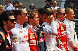 Daniil Kvyat (RUS) Red Bull Racing and Sebastian Vettel (GER) Ferrari as the grid observes the national anthem. 17.04.2016. Formula 1 World Championship, Rd 3, Chinese Grand Prix, Shanghai, China, Race Day.
