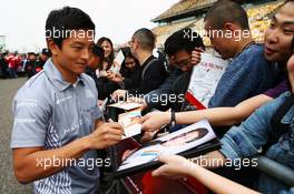 Rio Haryanto (IDN) Manor Racing signs autographs for the fans. 14.04.2016. Formula 1 World Championship, Rd 3, Chinese Grand Prix, Shanghai, China, Preparation Day.