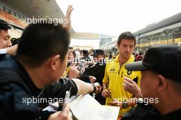 Jolyon Palmer (GBR) Renault Sport F1 Team signs autographs for the fans. 14.04.2016. Formula 1 World Championship, Rd 3, Chinese Grand Prix, Shanghai, China, Preparation Day.
