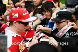Kimi Raikkonen (FIN) Ferrari signs autographs for the fans. 14.04.2016. Formula 1 World Championship, Rd 3, Chinese Grand Prix, Shanghai, China, Preparation Day.