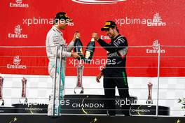 (L to R): Race winner Nico Rosberg (GER) Mercedes AMG F1 celebrates with the champagne on the podium with third placed Sergio Perez (MEX) Sahara Force India F1. 19.06.2016. Formula 1 World Championship, Rd 8, European Grand Prix, Baku Street Circuit, Azerbaijan, Race Day.