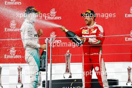 (L to R): Race winner Nico Rosberg (GER) Mercedes AMG F1 celebrates with the champagne on the podium with second placed Sebastian Vettel (GER) Ferrari. 19.06.2016. Formula 1 World Championship, Rd 8, European Grand Prix, Baku Street Circuit, Azerbaijan, Race Day.