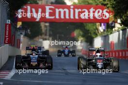 (L to R): Carlos Sainz Jr (ESP) Scuderia Toro Rosso STR11 and Jenson Button (GBR) McLaren MP4-31 battle for position. 19.06.2016. Formula 1 World Championship, Rd 8, European Grand Prix, Baku Street Circuit, Azerbaijan, Race Day.