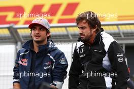 (L to R): Carlos Sainz Jr (ESP) Scuderia Toro Rosso with Fernando Alonso (ESP) McLaren on the drivers parade. 10.07.2016. Formula 1 World Championship, Rd 10, British Grand Prix, Silverstone, England, Race Day.