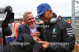 Lewis Hamilton (GBR) Mercedes AMG F1 with Johnny Herbert (GBR) Sky Sports F1 Presenter on the drivers parade. 10.07.2016. Formula 1 World Championship, Rd 10, British Grand Prix, Silverstone, England, Race Day.