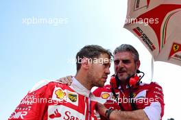 Sebastian Vettel (GER) Ferrari with Maurizio Arrivabene (ITA) Ferrari Team Principal on the grid. 24.07.2016. Formula 1 World Championship, Rd 11, Hungarian Grand Prix, Budapest, Hungary, Race Day.