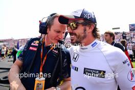 (L to R): Paul Monaghan (GBR) Red Bull Racing Chief Engineer with Fernando Alonso (ESP) McLaren on the grid. 24.07.2016. Formula 1 World Championship, Rd 11, Hungarian Grand Prix, Budapest, Hungary, Race Day.