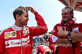 Sebastian Vettel (GER) Ferrari with Maurizio Arrivabene (ITA) Ferrari Team Principal on the grid. 24.07.2016. Formula 1 World Championship, Rd 11, Hungarian Grand Prix, Budapest, Hungary, Race Day.