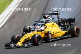 Kevin Magnussen (DEN) Renault Sport F1 Team RS16 and Fernando Alonso (ESP) McLaren MP4-31 battle for position. 24.07.2016. Formula 1 World Championship, Rd 11, Hungarian Grand Prix, Budapest, Hungary, Race Day.