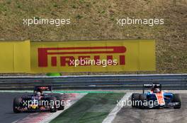 Pascal Wehrlein (GER) Manor Racing MRT05 runs wide alongside Daniil Kvyat (RUS) Scuderia Toro Rosso STR11. 24.07.2016. Formula 1 World Championship, Rd 11, Hungarian Grand Prix, Budapest, Hungary, Race Day.