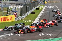 (L to R): Lewis Hamilton (GBR) Mercedes AMG F1; Nico Rosberg (GER) Mercedes AMG F1; and Daniel Ricciardo (AUS) Red Bull Racing battle for the lead at the start of the race. 24.07.2016. Formula 1 World Championship, Rd 11, Hungarian Grand Prix, Budapest, Hungary, Race Day.