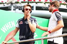 (L to R): Daniil Kvyat (RUS) Scuderia Toro Rosso with Romain Grosjean (FRA) Haas F1 Team on the drivers parade. 04.09.2016. Formula 1 World Championship, Rd 14, Italian Grand Prix, Monza, Italy, Race Day.