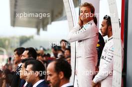 Race winner Nico Rosberg (GER) Mercedes AMG F1 with team mate Lewis Hamilton (GBR) Mercedes AMG F1 on the podium. 09.10.2016. Formula 1 World Championship, Rd 17, Japanese Grand Prix, Suzuka, Japan, Race Day.