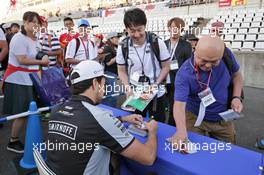 Sergio Perez (MEX) Sahara Force India F1 signs autographs for the fans. 06.10.2016. Formula 1 World Championship, Rd 17, Japanese Grand Prix, Suzuka, Japan, Preparation Day.