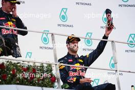 Race winner Daniel Ricciardo (AUS) Red Bull Racing celebrates on the podium with his race boot. 02.10.2016. Formula 1 World Championship, Rd 16, Malaysian Grand Prix, Sepang, Malaysia, Sunday.