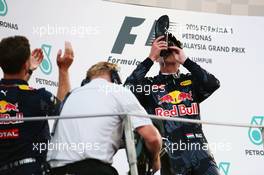 Second placed Max Verstappen (NLD) Red Bull Racing celebrates on the podium by drinking champagne from the race boot of race winner Daniel Ricciardo (AUS) Red Bull Racing. 02.10.2016. Formula 1 World Championship, Rd 16, Malaysian Grand Prix, Sepang, Malaysia, Sunday.