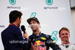 Race winner Daniel Ricciardo (AUS) Red Bull Racing on the podium with Mark Webber (AUS) Porsche Team WEC Driver / Channel 4 Presenter. 02.10.2016. Formula 1 World Championship, Rd 16, Malaysian Grand Prix, Sepang, Malaysia, Sunday.