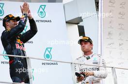 Third placed Nico Rosberg (GER) Mercedes AMG F1 celebrates on the podium by drinking champagne from the race boot of race winner Daniel Ricciardo (AUS) Red Bull Racing. 02.10.2016. Formula 1 World Championship, Rd 16, Malaysian Grand Prix, Sepang, Malaysia, Sunday.