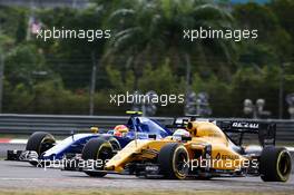 Kevin Magnussen (DEN) Renault Sport F1 Team RS16 and Felipe Nasr (BRA) Sauber C35. 01.10.2016. Formula 1 World Championship, Rd 16, Malaysian Grand Prix, Sepang, Malaysia, Saturday.