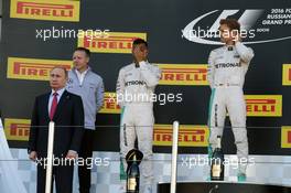 The podium (L to R): Vladimir Putin (RUS) Russian Federation President; Lewis Hamilton (GBR) Mercedes AMG F1, second; Nico Rosberg (GER) Mercedes AMG F1, race winner. 01.05.2016. Formula 1 World Championship, Rd 4, Russian Grand Prix, Sochi Autodrom, Sochi, Russia, Race Day.