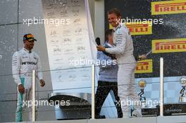 Race winner Nico Rosberg (GER) Mercedes AMG F1 celebrates with the champagne with team mate Lewis Hamilton (GBR) Mercedes AMG F1. 01.05.2016. Formula 1 World Championship, Rd 4, Russian Grand Prix, Sochi Autodrom, Sochi, Russia, Race Day.