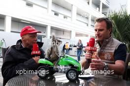 (L to R): Niki Lauda (AUT) Mercedes Non-Executive Chairman and Ernst Hausleitner (AUT) ORF Presenter with a squirrel on a quad bike. 30.04.2016. Formula 1 World Championship, Rd 4, Russian Grand Prix, Sochi Autodrom, Sochi, Russia, Qualifying Day.