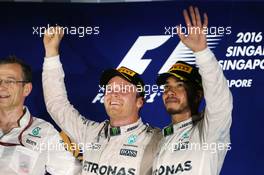 (L to R): Race winner Nico Rosberg (GER) Mercedes AMG F1 celebrates on the podium with third placed team mate Lewis Hamilton (GBR) Mercedes AMG F1. 18.09.2016. Formula 1 World Championship, Rd 15, Singapore Grand Prix, Marina Bay Street Circuit, Singapore, Race Day.