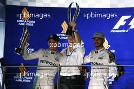 Race winner Nico Rosberg (GER) Mercedes AMG F1 (Left) with third placed team mate Lewis Hamilton (GBR) Mercedes AMG F1 (Right) on the podium. 18.09.2016. Formula 1 World Championship, Rd 15, Singapore Grand Prix, Marina Bay Street Circuit, Singapore, Race Day.