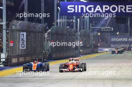 Sebastian Vettel (GER) Ferrari SF16-H and Pascal Wehrlein (GER) Manor Racing MRT05 battle for position. 18.09.2016. Formula 1 World Championship, Rd 15, Singapore Grand Prix, Marina Bay Street Circuit, Singapore, Race Day.