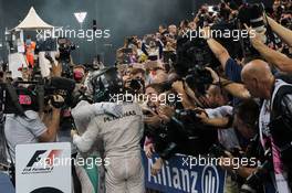 (L to R): Race winner Lewis Hamilton (GBR) Mercedes AMG F1 celebrates with second placed World Champion Nico Rosberg (GER) Mercedes AMG F1 in parc ferme. 27.11.2016. Formula 1 World Championship, Rd 21, Abu Dhabi Grand Prix, Yas Marina Circuit, Abu Dhabi, Race Day.