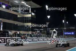 (L to R): Race winner Lewis Hamilton (GBR) Mercedes AMG F1 W07 Hybrid takes the chequered flag at the end of the race with second placed team mate and World Champion Nico Rosberg (GER) Mercedes AMG F1 W07 Hybrid. 27.11.2016. Formula 1 World Championship, Rd 21, Abu Dhabi Grand Prix, Yas Marina Circuit, Abu Dhabi, Race Day.