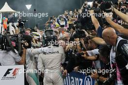 (L to R): Race winner Lewis Hamilton (GBR) Mercedes AMG F1 celebrates with second placed World Champion Nico Rosberg (GER) Mercedes AMG F1 in parc ferme. 27.11.2016. Formula 1 World Championship, Rd 21, Abu Dhabi Grand Prix, Yas Marina Circuit, Abu Dhabi, Race Day.