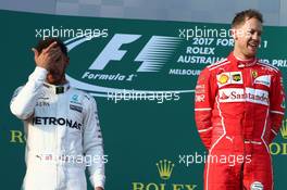 2nd place Lewis Hamilton (GBR) Mercedes AMG F1 with 1st place Sebastian Vettel (GER) Ferrari. 26.03.2017. Formula 1 World Championship, Rd 1, Australian Grand Prix, Albert Park, Melbourne, Australia, Race Day.