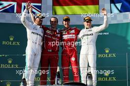 The podium (L to R): Lewis Hamilton (GBR) Mercedes AMG F1, second; Sebastian Vettel (GER) Ferrari, race winner; Valtteri Bottas (FIN) Mercedes AMG F1, third. 26.03.2017. Formula 1 World Championship, Rd 1, Australian Grand Prix, Albert Park, Melbourne, Australia, Race Day.
