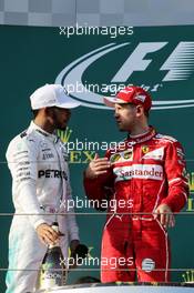 (L to R): Lewis Hamilton (GBR) Mercedes AMG F1 with race winner Sebastian Vettel (GER) Ferrari on the podium. 26.03.2017. Formula 1 World Championship, Rd 1, Australian Grand Prix, Albert Park, Melbourne, Australia, Race Day.