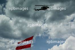 A helicopted with an Austrian flag. 09.07.2017. Formula 1 World Championship, Rd 9, Austrian Grand Prix, Spielberg, Austria, Race Day.