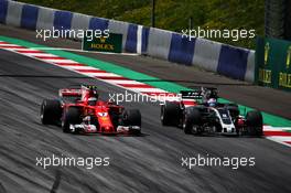 Kimi Raikkonen (FIN) Ferrari SF70H and Romain Grosjean (FRA) Haas F1 Team VF-17 battle for position. 09.07.2017. Formula 1 World Championship, Rd 9, Austrian Grand Prix, Spielberg, Austria, Race Day.