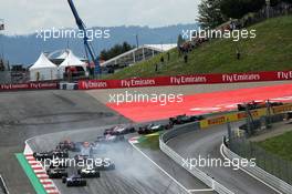 Daniil Kvyat (RUS) Scuderia Toro Rosso STR12 locks up under braking at the start of the race, hitting Fernando Alonso (ESP) McLaren MCL32 and Max Verstappen (NLD) Red Bull Racing RB13. 09.07.2017. Formula 1 World Championship, Rd 9, Austrian Grand Prix, Spielberg, Austria, Race Day.