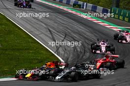Daniel Ricciardo (AUS) Red Bull Racing RB13 and Romain Grosjean (FRA) Haas F1 Team VF-17 battle for position at the start of the race. 09.07.2017. Formula 1 World Championship, Rd 9, Austrian Grand Prix, Spielberg, Austria, Race Day.