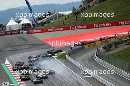 Daniil Kvyat (RUS) Scuderia Toro Rosso STR12 locks up under braking at the start of the race, hitting Fernando Alonso (ESP) McLaren MCL32. 09.07.2017. Formula 1 World Championship, Rd 9, Austrian Grand Prix, Spielberg, Austria, Race Day.