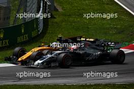 Jolyon Palmer (GBR) Renault Sport F1 Team RS17 and Kevin Magnussen (DEN) Haas VF-17 battle for position. 09.07.2017. Formula 1 World Championship, Rd 9, Austrian Grand Prix, Spielberg, Austria, Race Day.