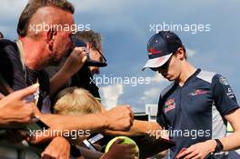 Daniil Kvyat (RUS) Scuderia Toro Rosso signs autographs for the fans. 06.07.2017. Formula 1 World Championship, Rd 9, Austrian Grand Prix, Spielberg, Austria, Preparation Day.